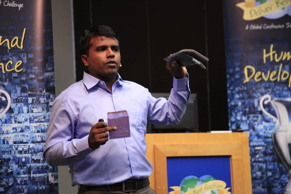 Nikhil Pal presenting on stage at Jabil's Deliver Best Practices event, 2012
