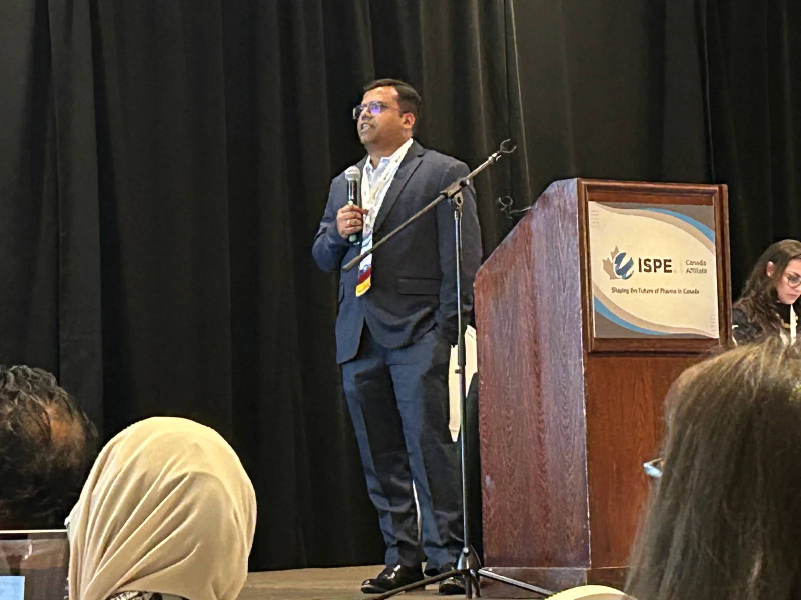 Nikhil Pal speaking from the podium at ISPE Canada, 2026